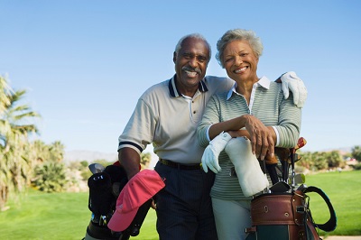 older man and woman playing golf