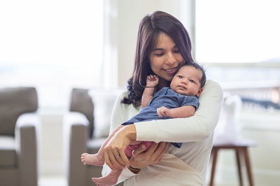 Smiling mom holding her baby