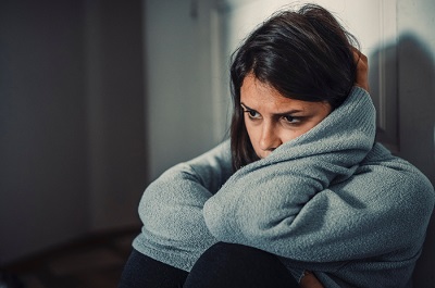 Sad woman in a dark room