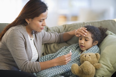 Mom checking her sick child's temperature