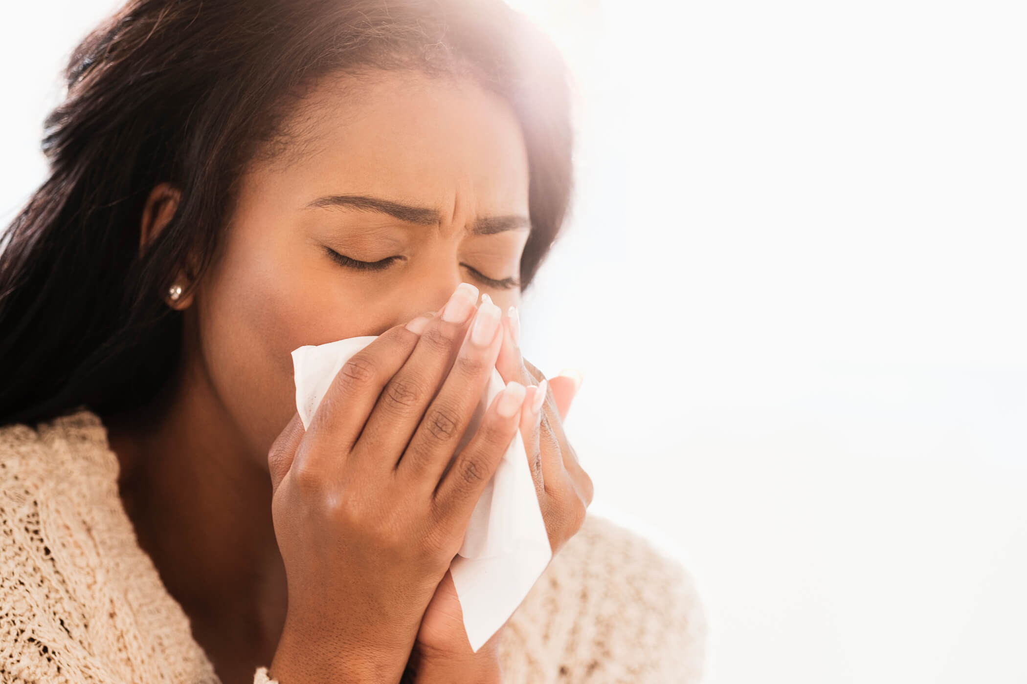 Woman blowing her nose